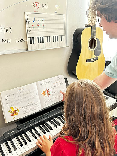 Alberto giving a piano lesson to a student in the studio in Coral Gables