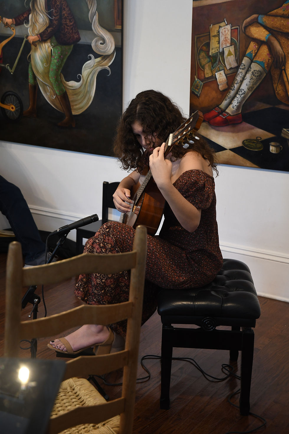 student performing classical guitar in an intimate recital space in Miami
