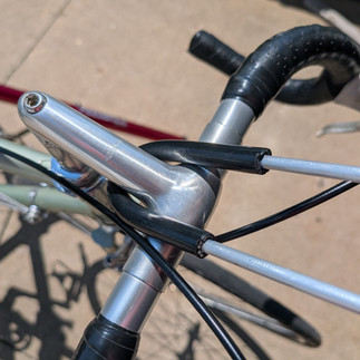 Aluminum rod looped around the bike stem, viewed from above