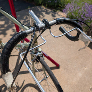 Rack installed on the bike with bag supports spaced in front of the bars