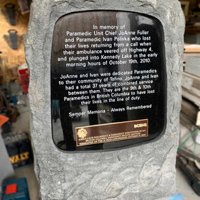 Stone memorial "In Memory of Paramedics Eva O'Shea, Alison Butler" and others.
