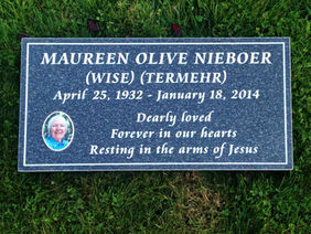 Maureen Olive Nieboer headstone with text, photo, and dates, surrounded by grass.