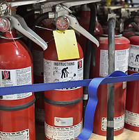 Fire extinguishers on storage rack in Alltron Systems recharge center