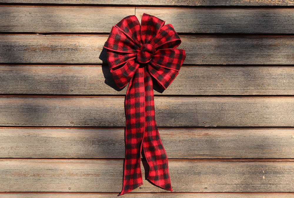 black and red bow on wooden wall