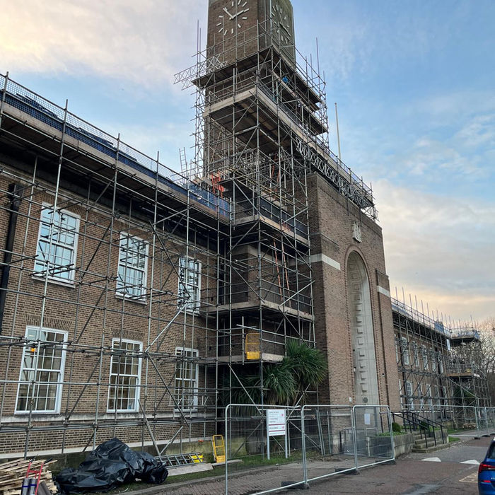 High-level scaffold structure erected around clock tower of historic town hall for inspection and repair access
