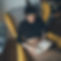 Woman sits in a chair and reads.
