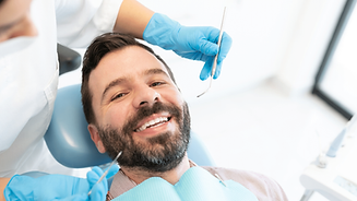 SMILING PATIENT AT DENTAL CLINIC.png
