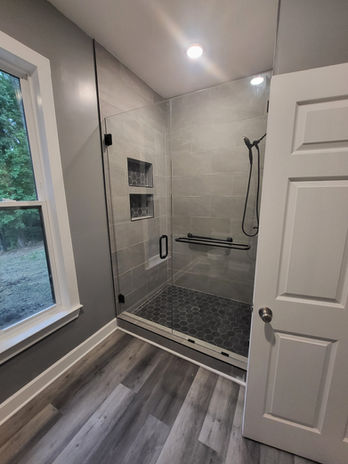 Remodeled bathroom featuring a glass walk-in shower