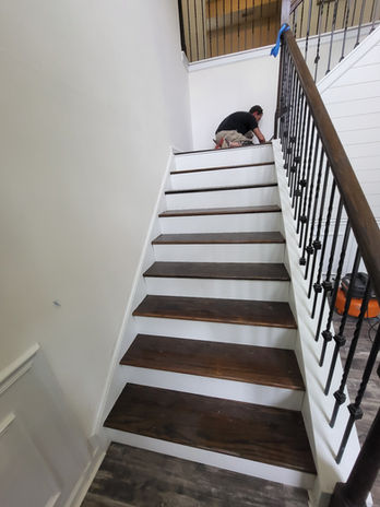 Worker on wooden staircase treads