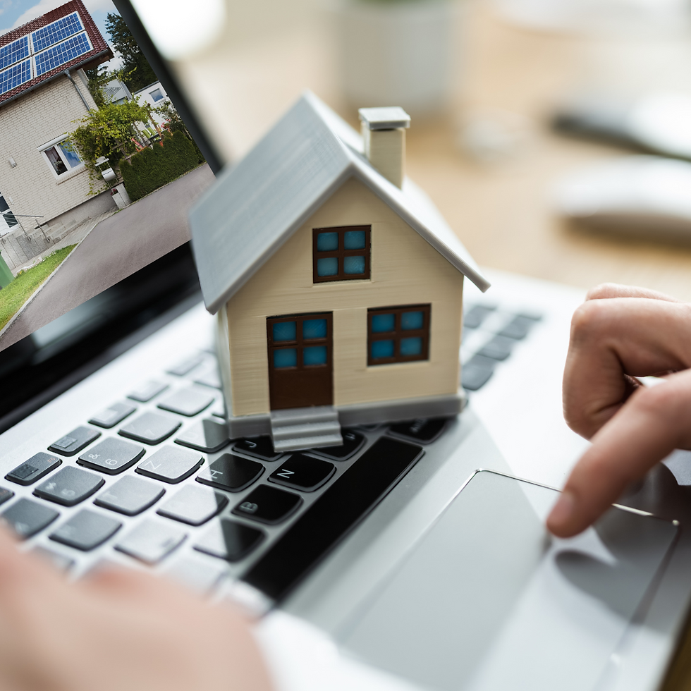 A laptop, tax documents, and toy house on a desk, symbolising tax planning for landlords.