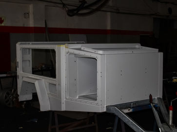 Final body assembly onto the chassis in preparation for the painting stage.