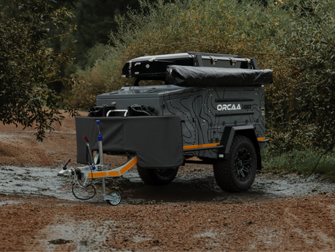 Side view of the ORCAA Legacy camper with the 270° awning neatly packed in its heavy-duty transit bag for off-road travel.