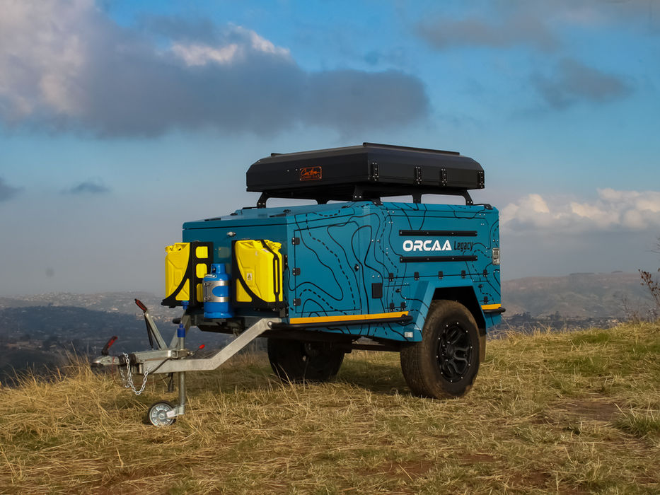 Trailer parked near the edge of a cliff, showcasing its stability and off-grid readiness in remote, elevated terrain.