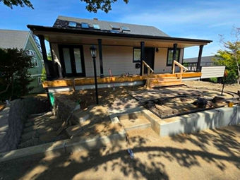 Home exterior with new siding, windows and a covered deck