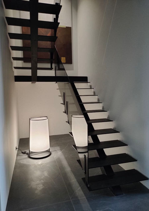 Чорні металеві сходи з тонованим склом у сучасному інтер’єрі
