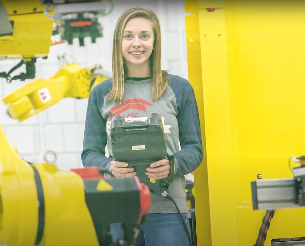 Blond woman in manufacturing plant holding controls