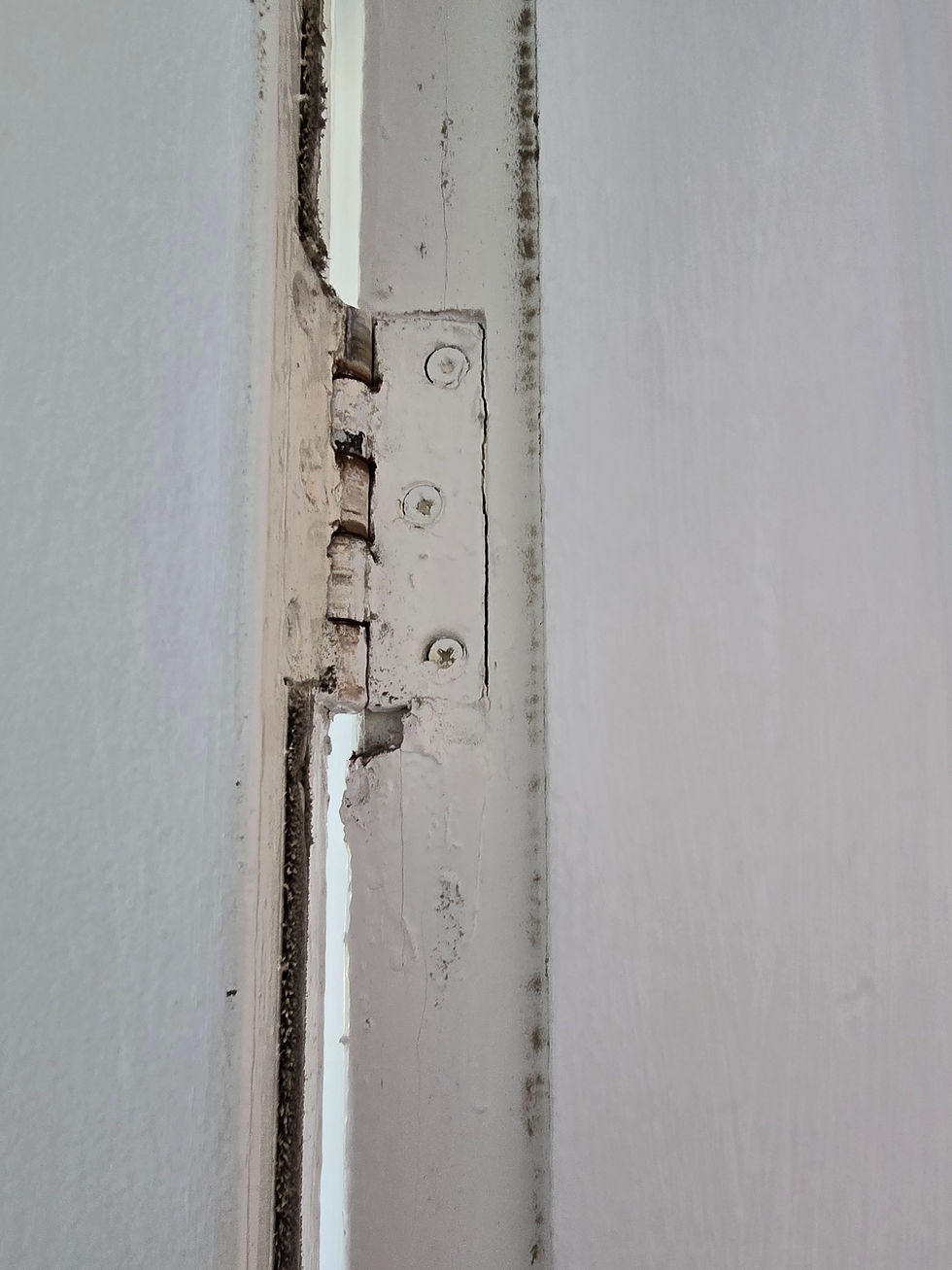 Eye-level view of a fire door with a damaged door closer