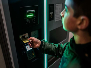 someone putting their card in an atm machine