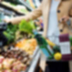 woman shopping in grocery store fruit and vegetables. cheapest supermarket delivery hero image