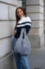 model holding a distorted gingham medium bag from Kind Bag