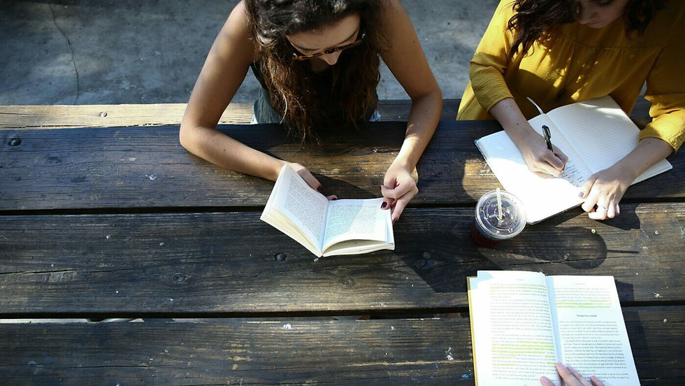 People studying and writing at a desk