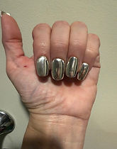 Client's hand wearing sterling silver press-on nails
