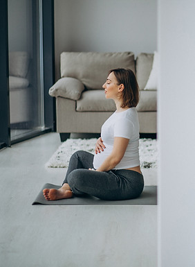 young-pregnant-woman-practicing-yoga-home.jpg