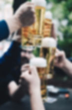 Photo of hands holding glasses full of beer