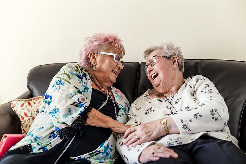 Two-older-women-on-a-sofa-laughing-scaled.jpg