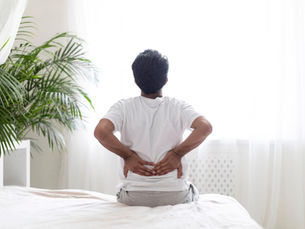Middle aged man waing up with chronic back pain
