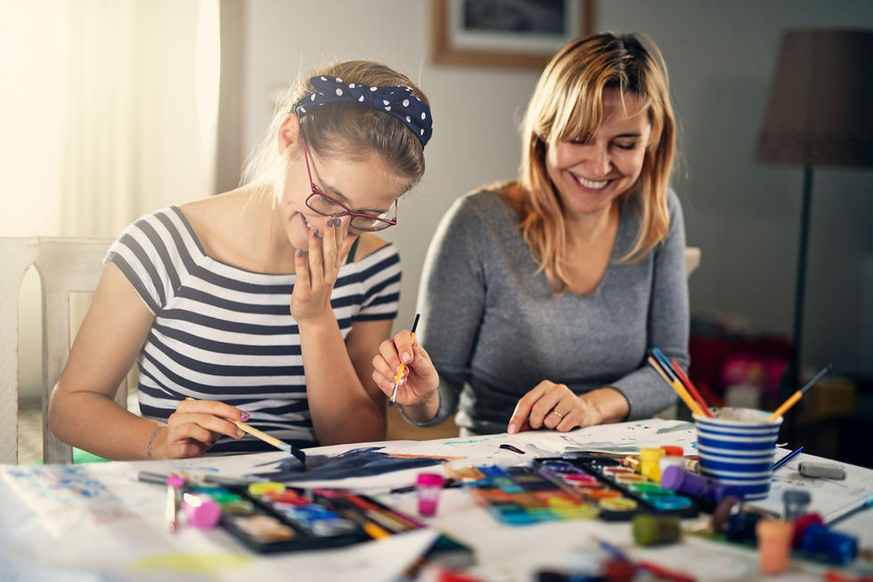 Mother and daughter being creative with arts at the table