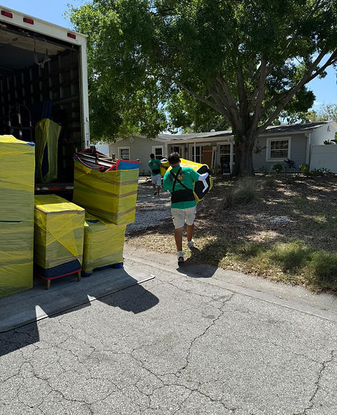 Mover carrying wrapped ottoman _ Phoenix Moving Solutions