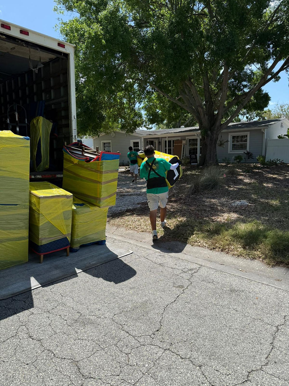 Mover carrying wrapped ottoman  _ Phoenix Moving Solutions