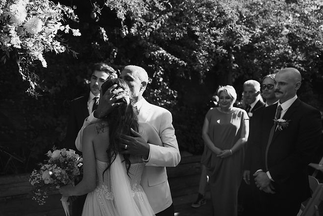 Emotional photograph of a bride and her father at the wedding ceremony, captured in black and white by Los Angeles wedding photographer Lesya Abbakumova