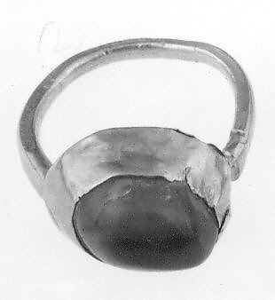 11th-13th Century. Gurgan, Iran. Gold sheet and sapphire. The asymmetry of the stone has posed a problem that the goldsmith has overcome by offsetting the bezel on the shank to better center the luminous blue mass of the stone. Dimensions not listed. Accession no. 52.32.4.