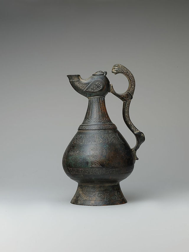 Late 12th Century. Iran. Brass; cast, chased, engraved, inlaid with silver and black compound. Inscriptions in Kufic and Naskhi:  Might, prosperity, power, health, happiness, to the owner. Victory and blessing, and power, and well-being, and happiness, and health, and victory, and intercession, and stability to the owner. The owner [is] `Ali bin `Abd al-Rahman bin Tahir al Adib (learned priest) the Sijzi (from Sistan). Victory and blessing, and power, and well-being, and happiness, and health, and victory, and intercession, and stability to the owner. The owner [is] `Ali bin `Abd al-Rahman bin Tahir al Adib (learned priest) the Sijzi (from Sistan). Accession no. 33.96