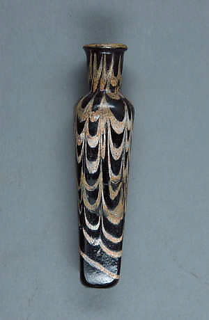 13th Century. Egypt or Syria. Glass, amber; blown with applied marvered opaque white decoration. H. 4 in. (10.2 cm). Accession no. 32.49.3.