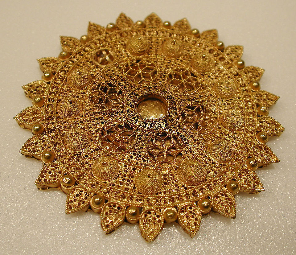 11th Century. Iran. Gold; filigree, granulation. The filigree on the surface is laid on a ground of thin, gold strips arranged in concentric circles.  D. 3/16 in. (0.5 cm) Diam. 2 13/16 in. (7.1 cm) Wt. 0.9 oz. (25.5 g). Accession no. 1980.344.