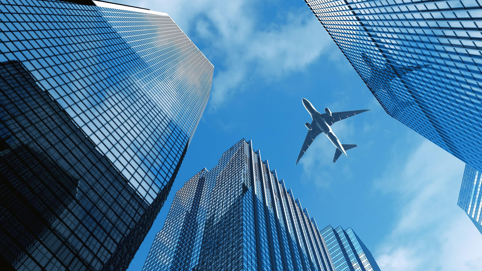 Plane flying over buildings