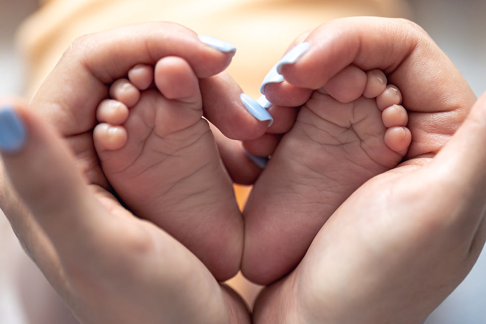 mom holding baby feet