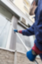 Worker cleaning windows