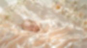 Sleeping infant surrounded by orange blossoms