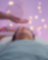 Woman receiving energy healing, serene expression