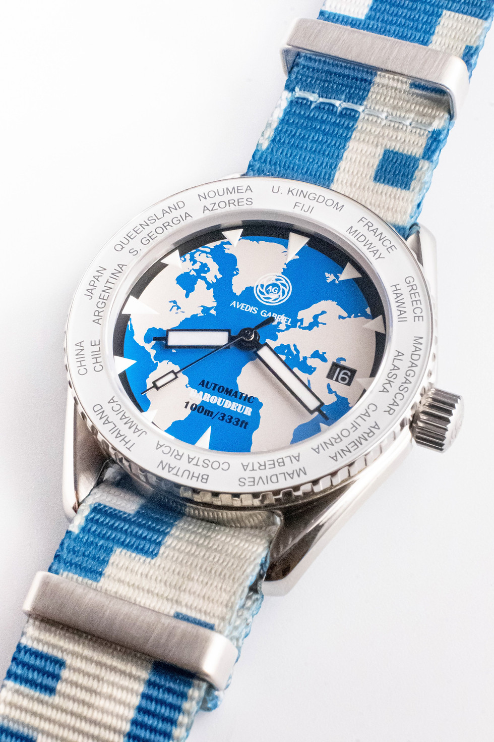 Thumbnail: Avedis Gabriel "Baroudeur" watch with white rotating bezel and world map dial and camo blue NATO strap