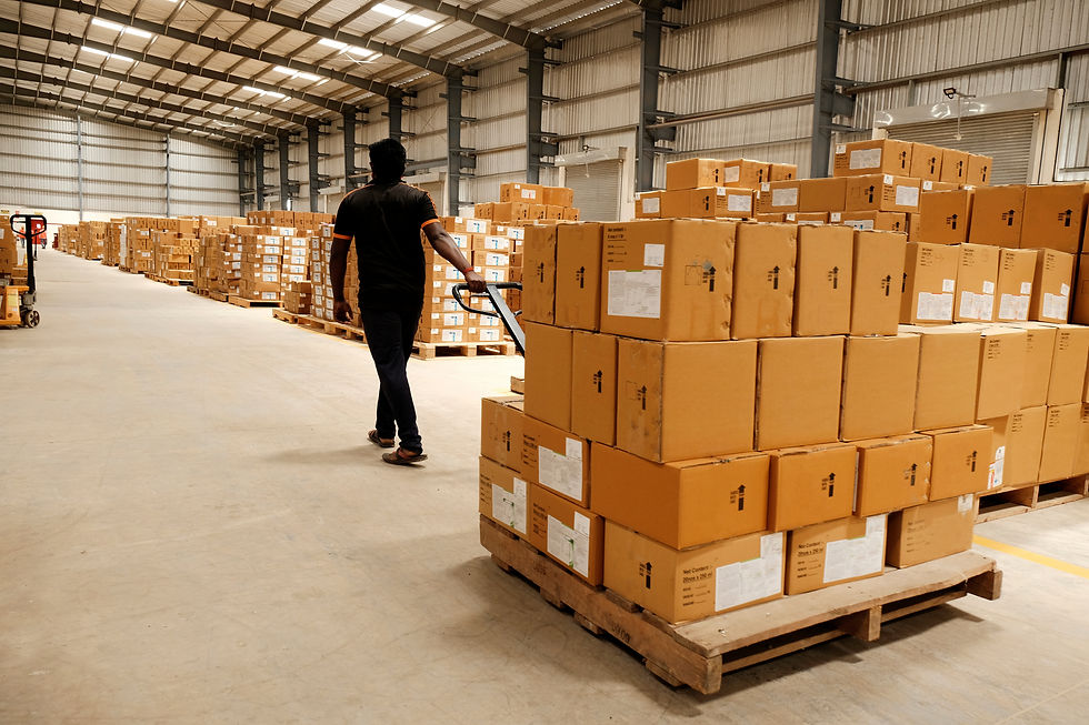 Warehouse workers loading boxed freight into a dry van trailer