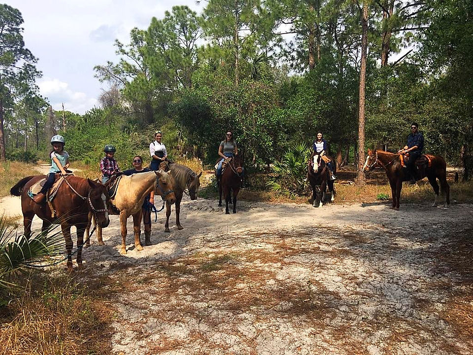 group of people riding horses