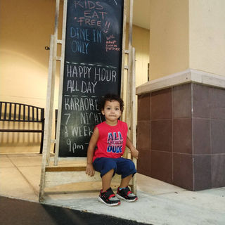 Little boy sitting outside