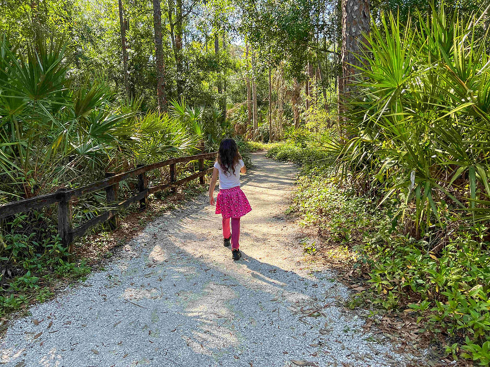 girl hikinh calusa nature center trail