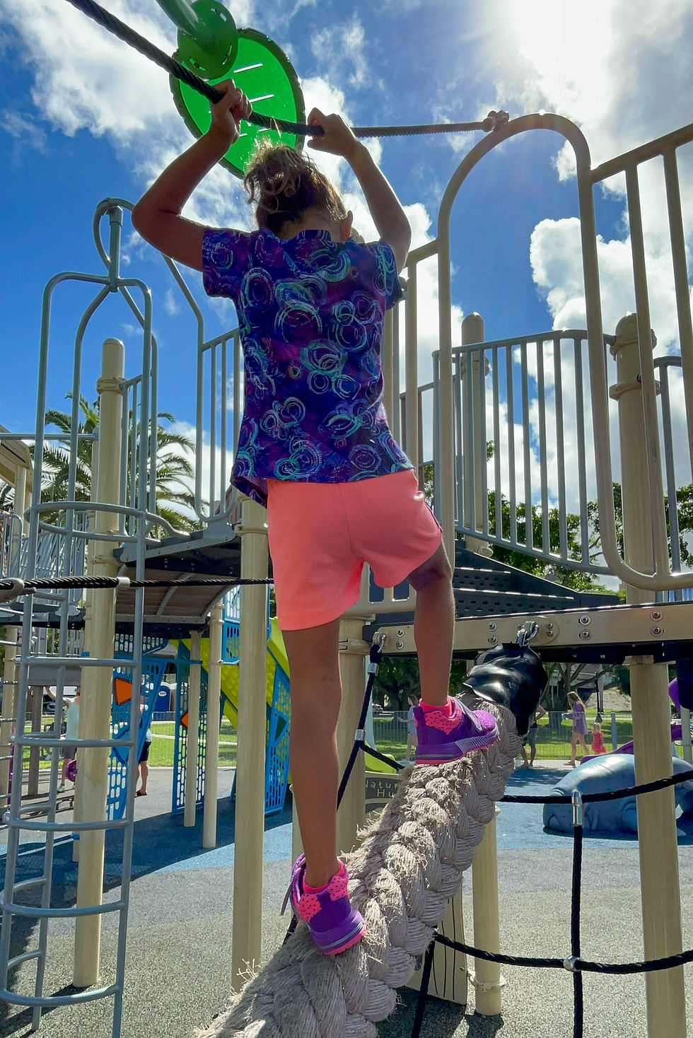 Girl climbing playground at Centennial Park in Fort Myers