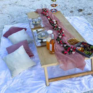 comfortable beach picnic set up in pink and cream
